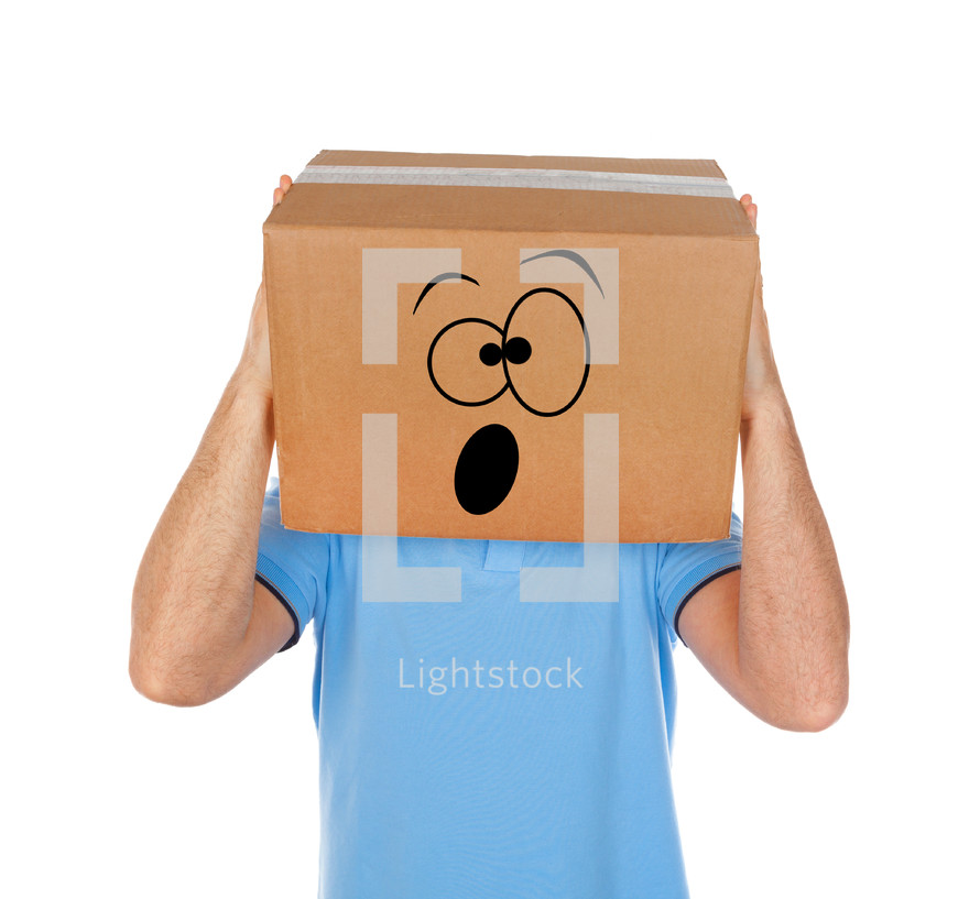 Young man standing with a cardboard box on his head with face on white background.