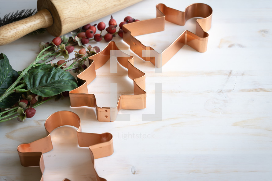 cooper Christmas cookie cutters on a white wood background 