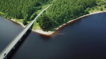 Aerial Pan of Cars Driving Across Baltyboys Bridge and Tracking Beach, Blessington, County Wicklow, Ireland
