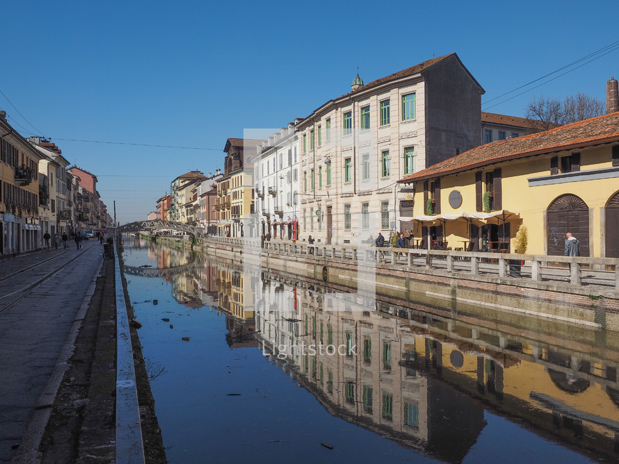 MILAN, ITALY - MARCH 28, 2015: Tourists at the Naviglio Grande canal waterway in Milan Italy