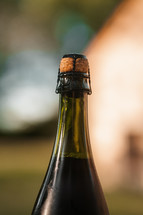 Wine bottle with cork, red wine in a green bottle