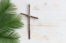 palm fronds and cross on a white background 