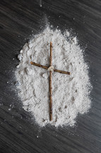 cross of sticks on ashes 