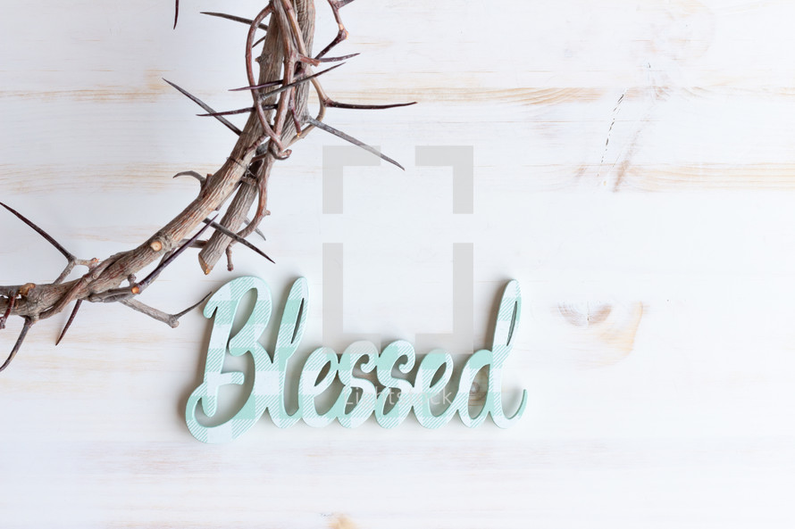 word blessed and crown of thorns on a white background 