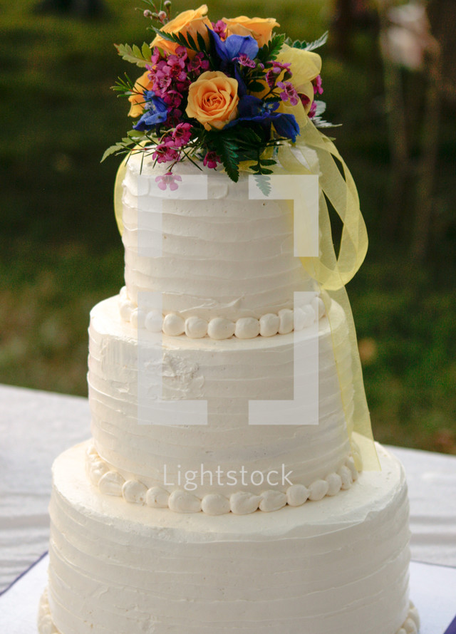 flowers on the top of a wedding cake 