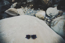 sunglasses on a rock 