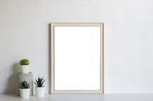 blank frame and succulents 