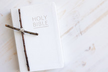 cross of sticks on a Bible 