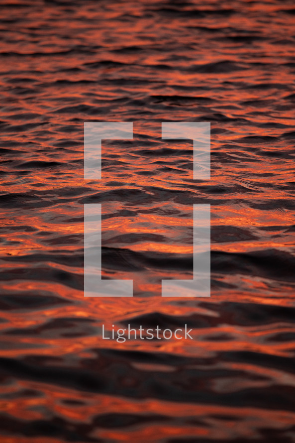 reflection of orange sky on water 