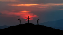 Silhouettes of three crosses at dusk
