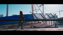 woman walking on a dock near a boat
