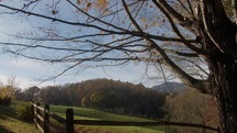 Beautiful Fall Morning in Smoky Mountains with Fence Around Farm and Rolling Hills