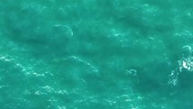 Aerial view of a blue sea water background. Flight over the sea. Aerial top down shot, 4K. 