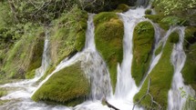 waterfall over mossy rocks 