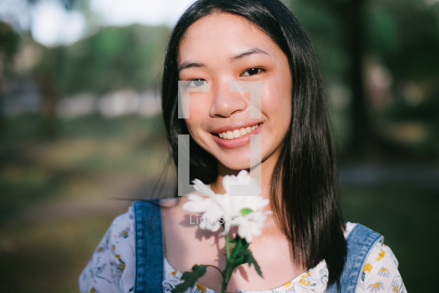 smiling young woman holding flowers 