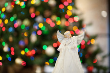 angel in front of a Christmas tree 