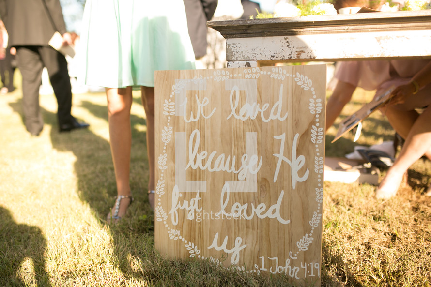 we loved because he first loved us sign at a wedding reception 