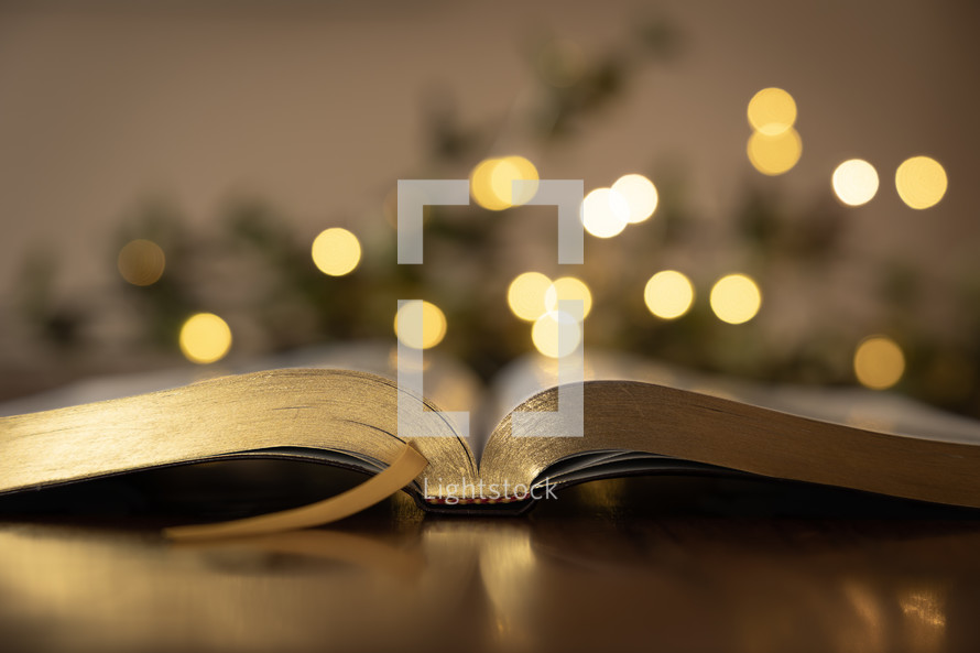 bokeh lights and open Bible at Christmas 