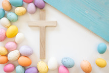 Wood cross with border of easter eggs on white background