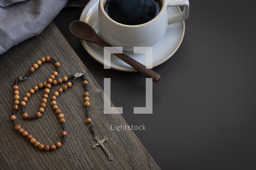 rosary, coffee cup, and wooden spoon 