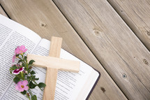 flowers and cross on the pages of a Bible 