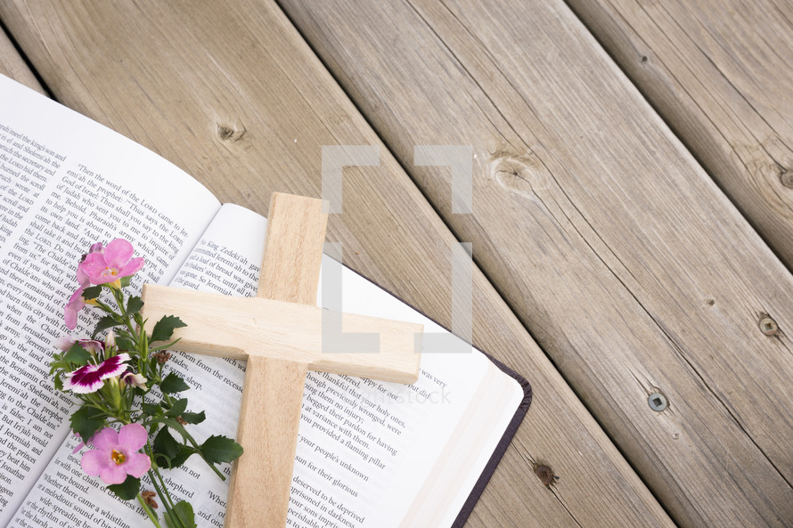 flowers and cross on the pages of a Bible 