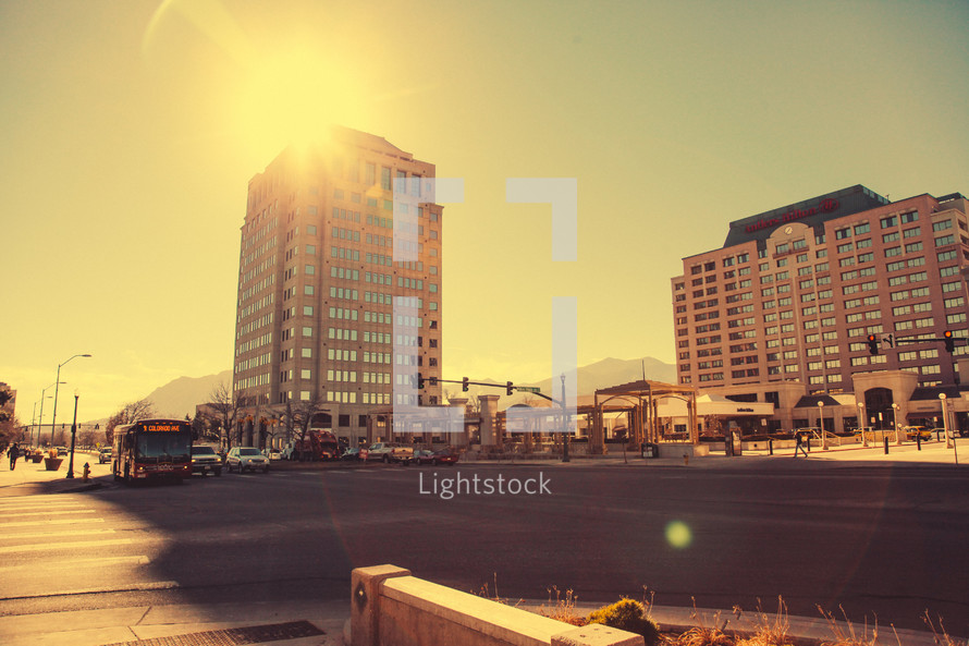 bright morning sunlight over a hotel and city street 