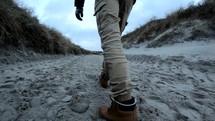 View of man walking on the beach in Germany.
