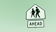 school crossing crosswalk ahead sign against light green background