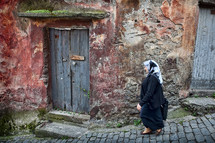 Muslim woman walking cobblestone