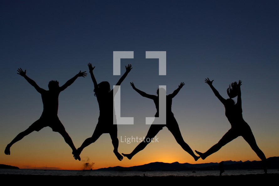 silhouette of youth jumping in the air at night 