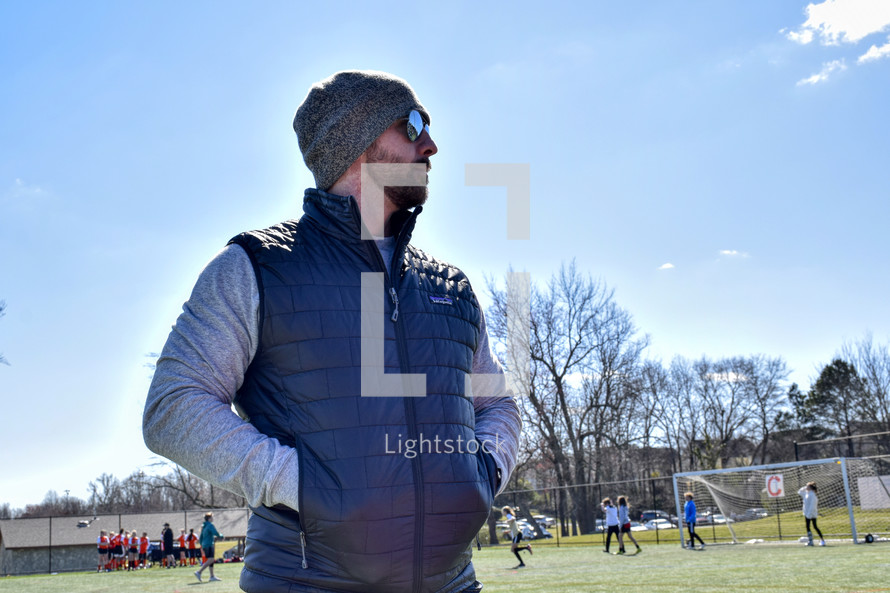 father watching a soccer game 