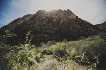 sunlight on desert mountain peak 