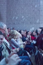 church congregation with falling snow at a Christmas service 