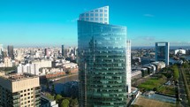 Cinematic close up aerial pan shot capturing reflective mirror glass window facade skyscrapers in downtown Buenos Aires central business district.
