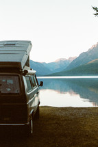 camper parked by a lake 