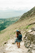 woman hiking down a mountainside 