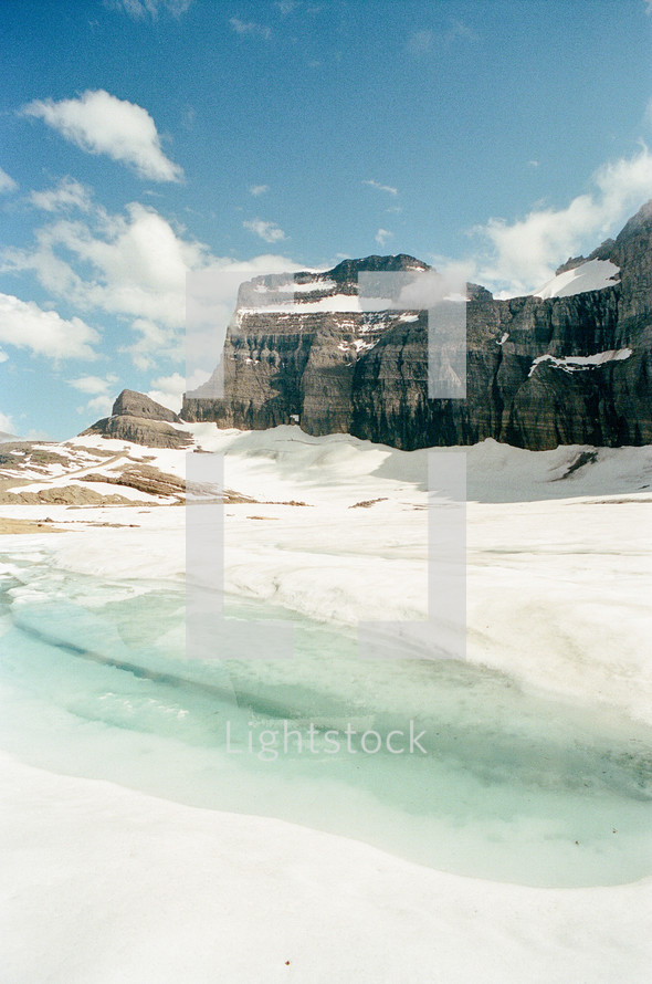 frozen lake and snow on a mountaintop 