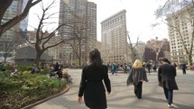 People in New York walking on Madison Square Park

