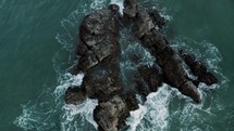 Ocean Waves Crashing On Rocky Outcrops Near The Town Of Puerto Escondido, Oaxaca, Mexico. aerial drone top-down