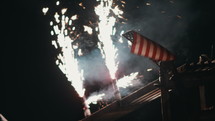 fireworks on the ground at night and American flag 