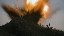 Miniature silhouettes of WWII American and German soldiers fighting under large explosion.
