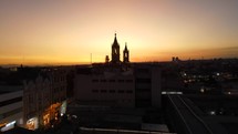 Aerial shot drone ascends over Arequipa Basilica Cathedral at sunset