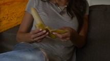 woman peels banana- close up 