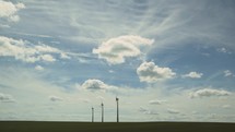Wind turbines and agricultural fields on a summer day - Energy Production with clean and Renewable Energy
