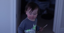 Toddler boy points before running away with smart phone - 120fps slow motion