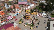 Aerial shot drone circles around orange tower in main square of port city