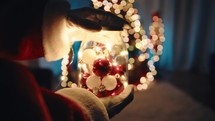 Santa Holding a Jar with Christmas ornaments