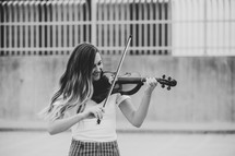 teen girl playing a violin 
