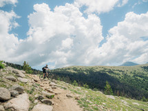 man mountain biking down a slope 